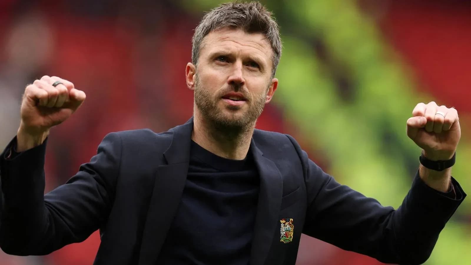 Coach celebrating with raised fists on pitch Coach celebrating with raised fists on pitch