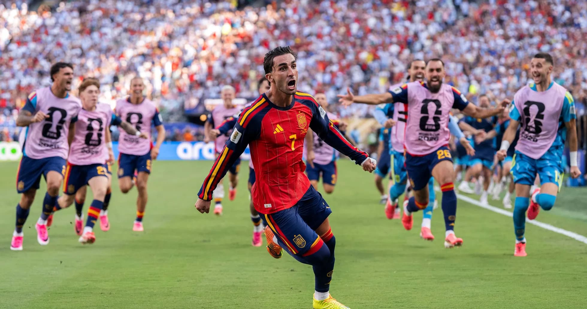 Spain player celebrating with teammates after scoring Spain player celebrating with teammates after scoring