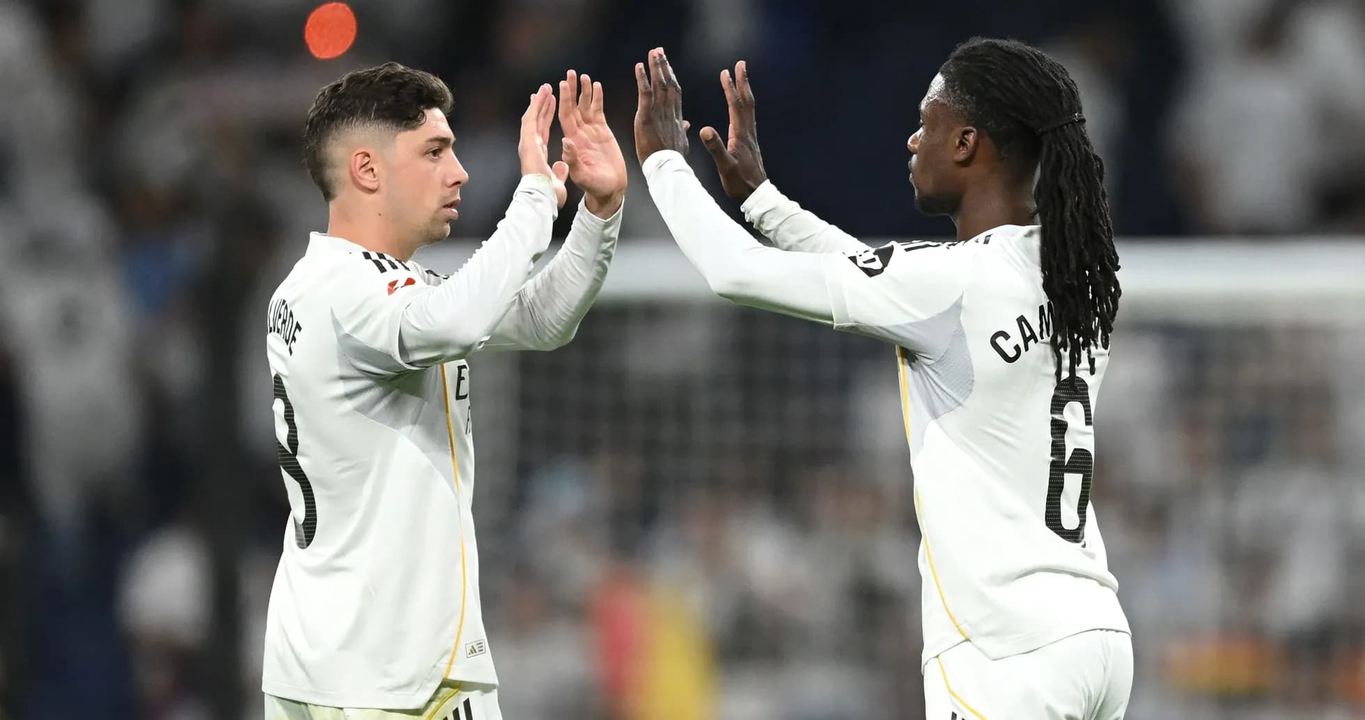 Two players high-fiving during a match celebration Two players high-fiving during a match celebration
