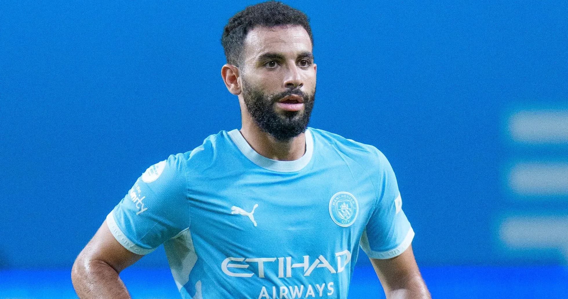 Player in Manchester City jersey on the pitch Player in Manchester City jersey on the pitch