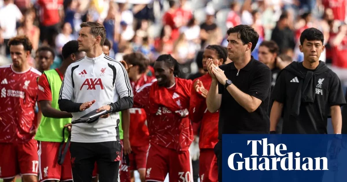 Liverpool players and staff walking off the pitch Liverpool players and staff walking off the pitch