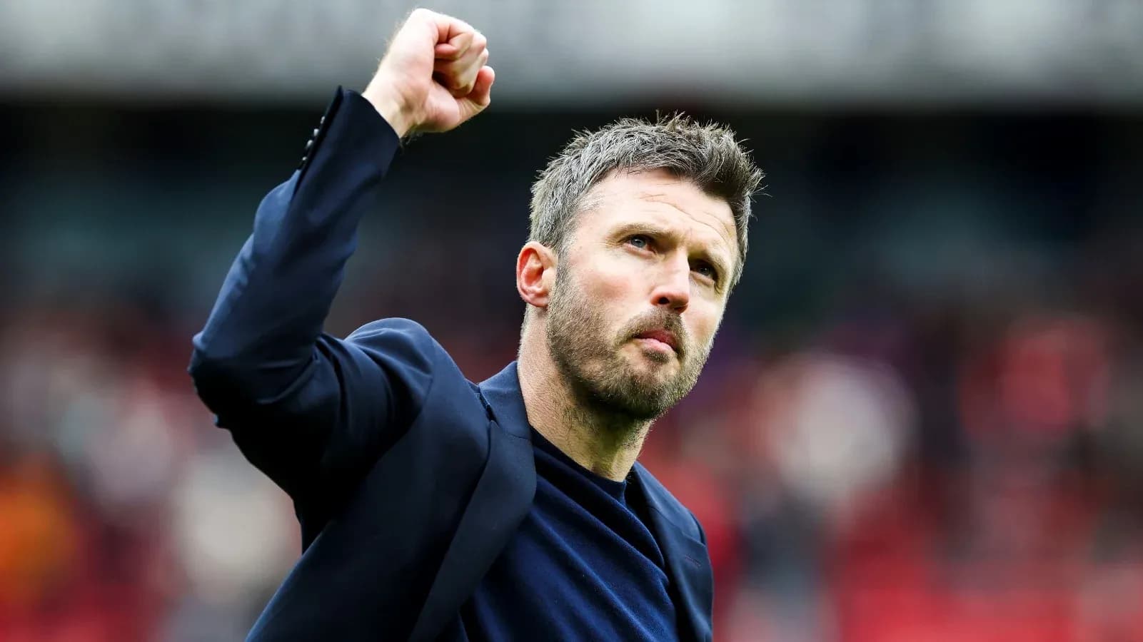 Manager celebrating with raised fist on pitch Manager celebrating with raised fist on pitch