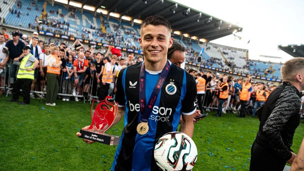 Player holding trophy and ball after match celebration Player holding trophy and ball after match celebration