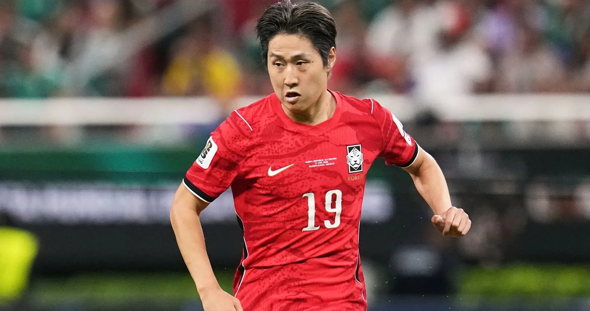 Player in red jersey running during soccer match Player in red jersey running during soccer match