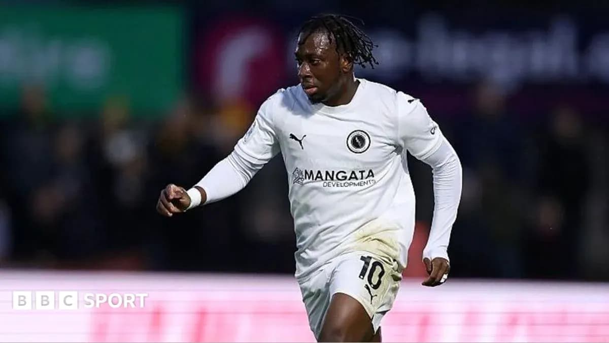 Player celebrating a goal in white jersey Player celebrating a goal in white jersey