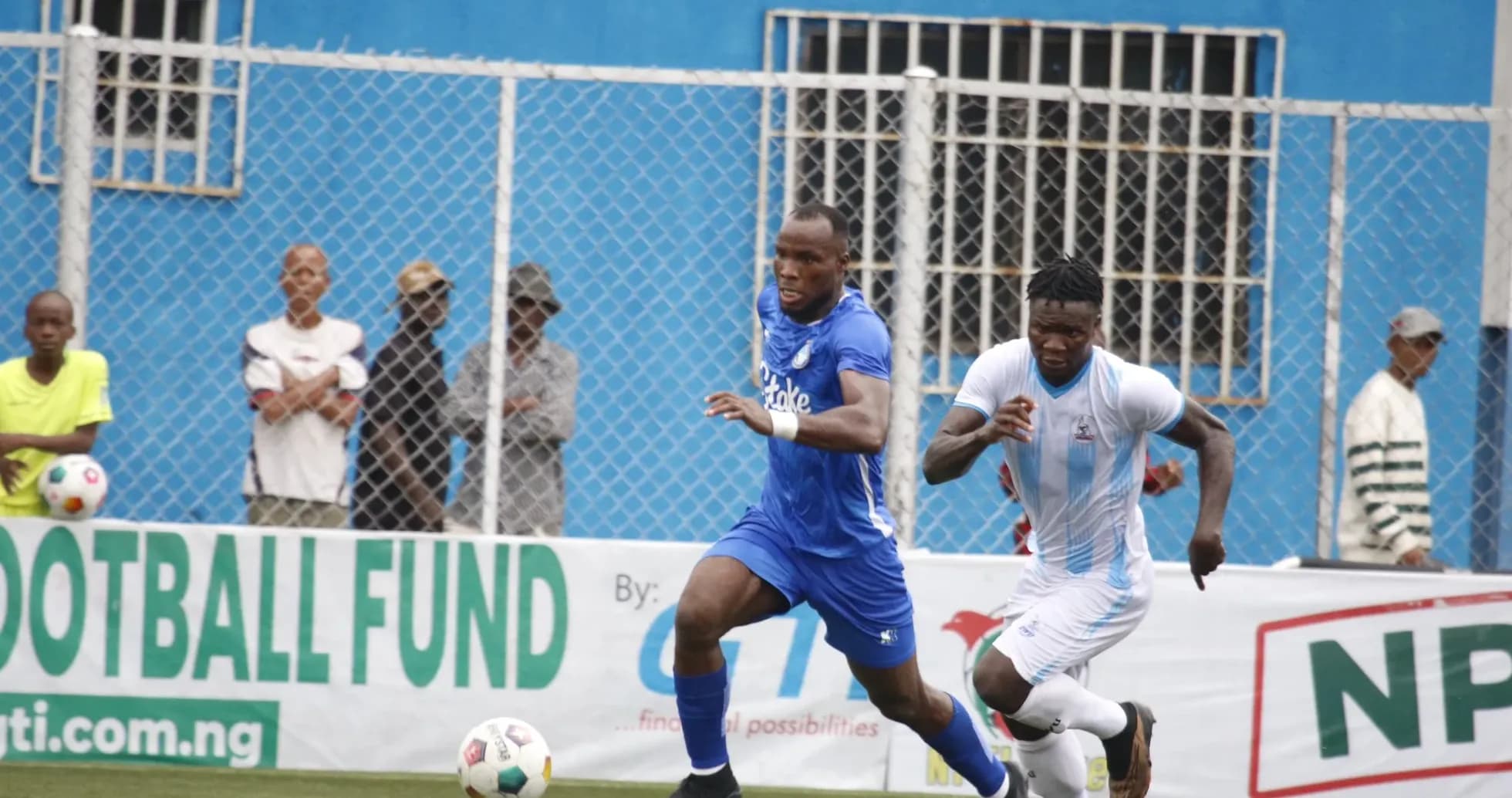 Two players competing for the ball in NPFL match Two players competing for the ball in NPFL match