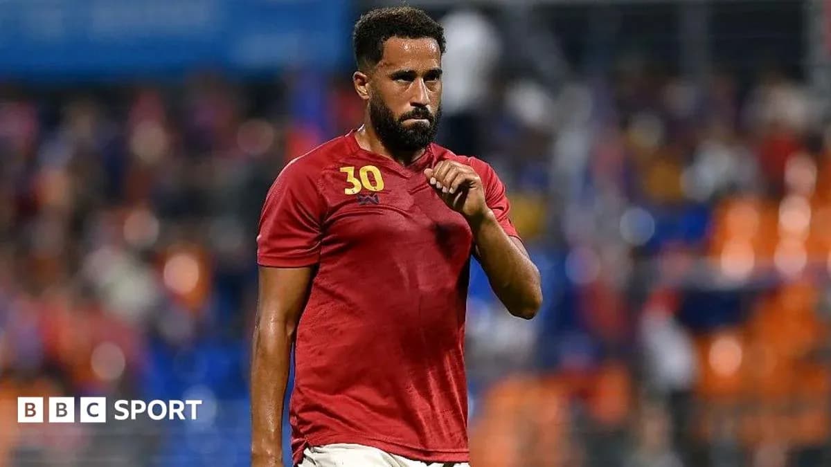 Player in red jersey walking on the field Player in red jersey walking on the field