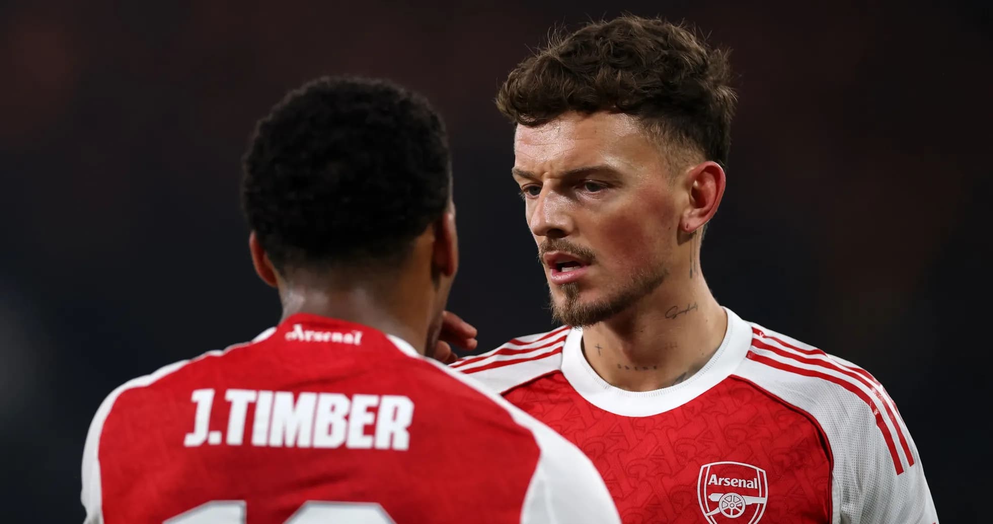 Two Arsenal players discussing on the pitch Two Arsenal players discussing on the pitch