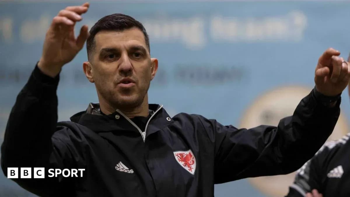 Coach gesturing while speaking to team during training Coach gesturing while speaking to team during training