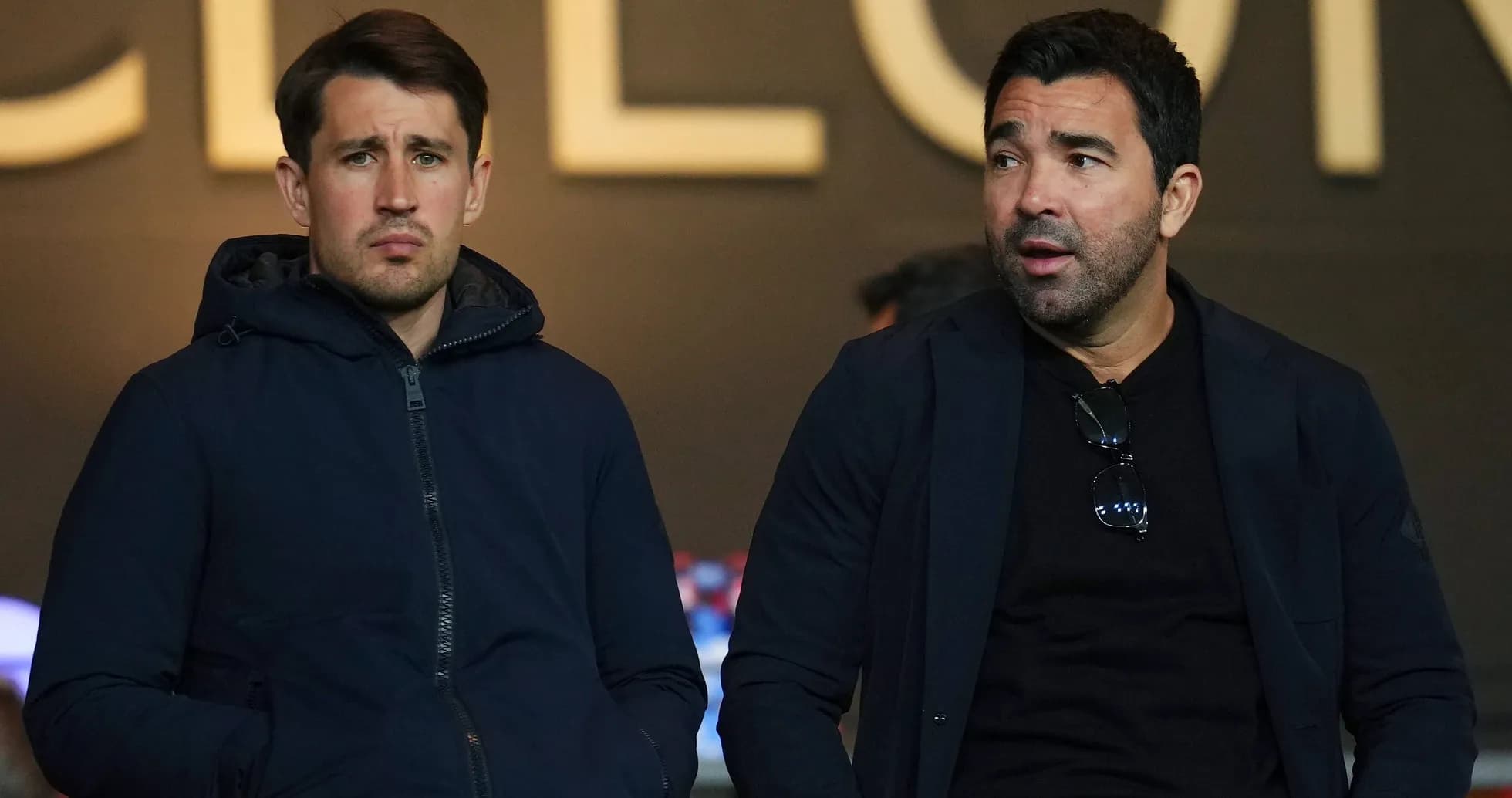 Two men sitting in a sports venue Two men sitting in a sports venue