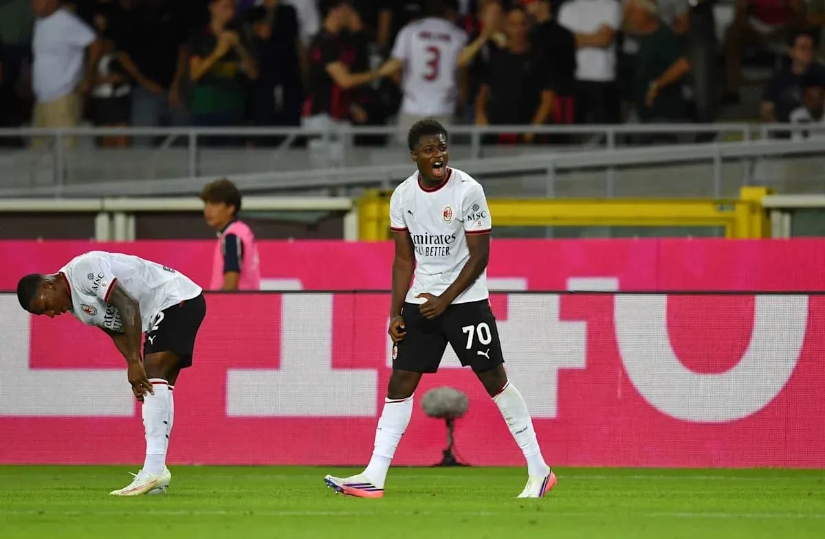 Player celebrating a goal with teammates in stadium Player celebrating a goal with teammates in stadium