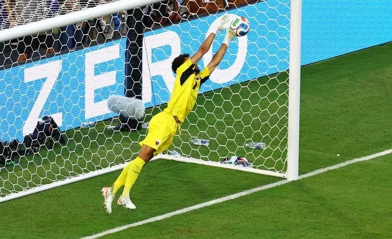 Goalkeeper diving to save a shot on goal Goalkeeper diving to save a shot on goal