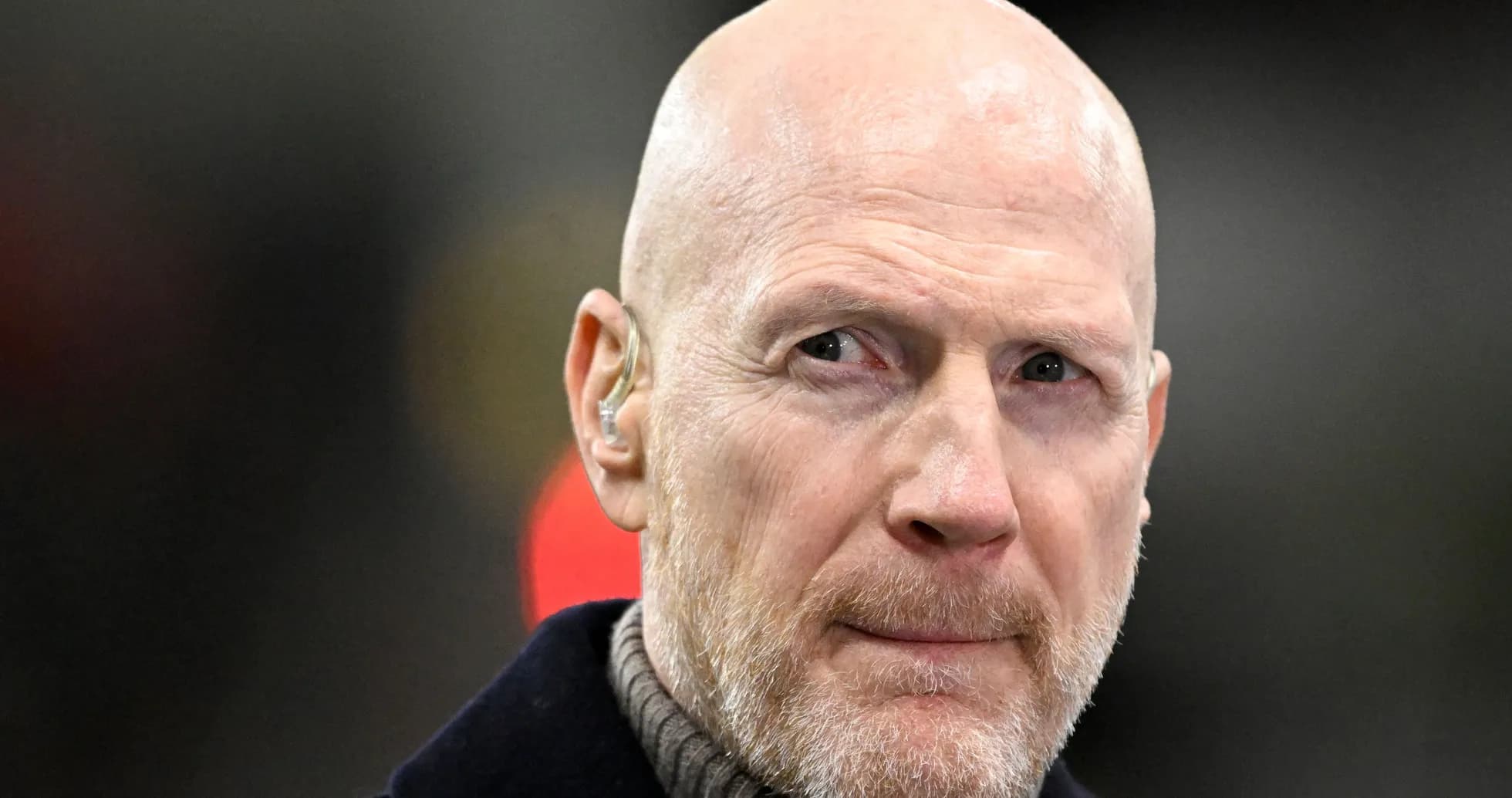 Bald man with a beard wearing an earpiece Bald man with a beard wearing an earpiece