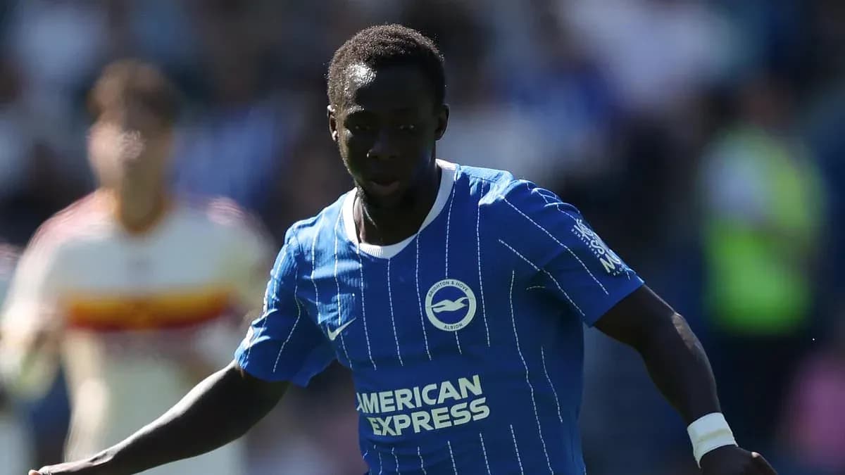 Player in blue kit running with the ball Player in blue kit running with the ball