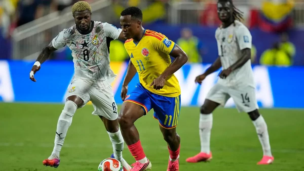 Colombian player dribbling past Ghanaian defender in match Colombian player dribbling past Ghanaian defender in match