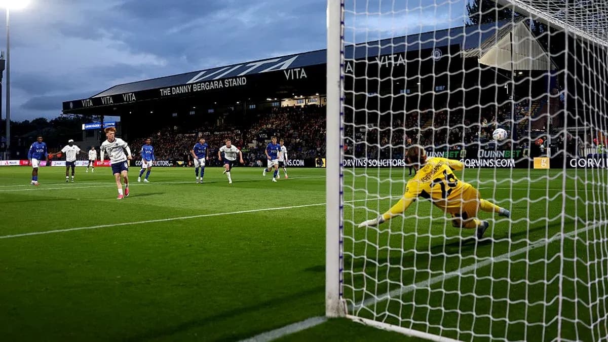 Player taking a penalty kick against the goalkeeper Player taking a penalty kick against the goalkeeper