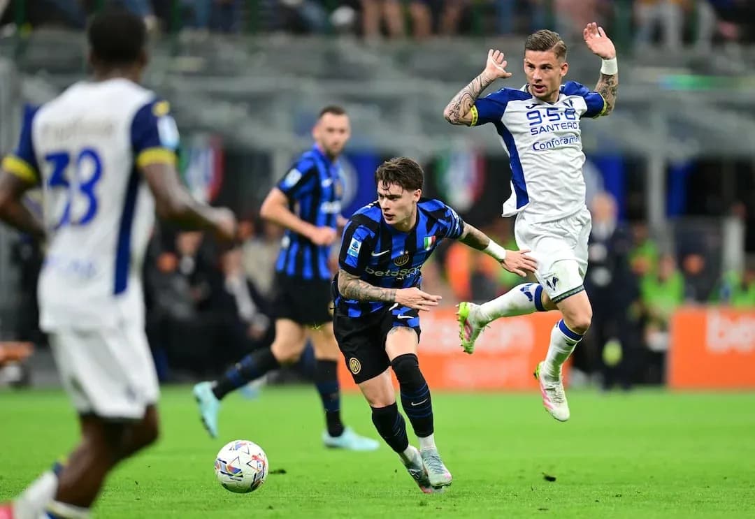 Inter player dribbling past Hellas Verona defender Inter player dribbling past Hellas Verona defender