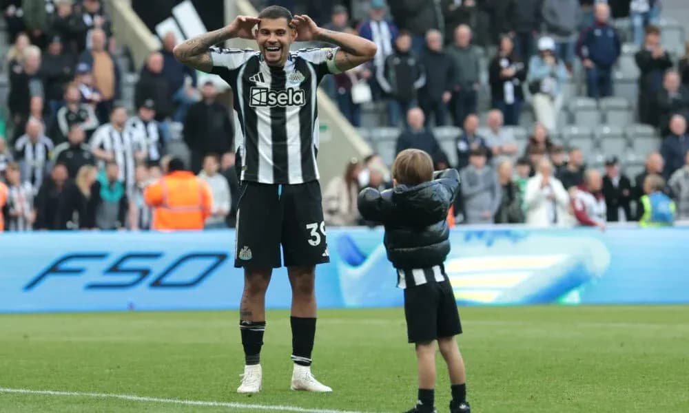 Newcastle player celebrating with a young fan Newcastle player celebrating with a young fan