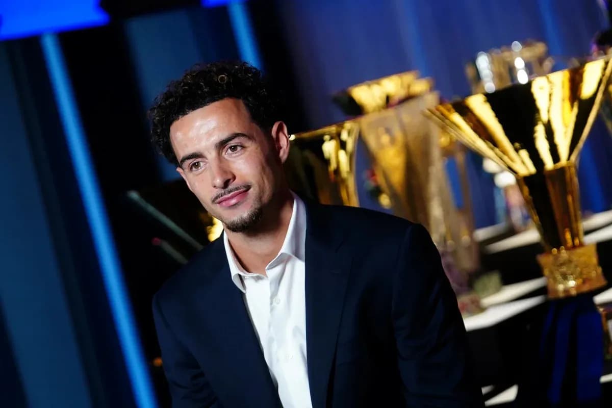 Player seated in front of trophy display Player seated in front of trophy display