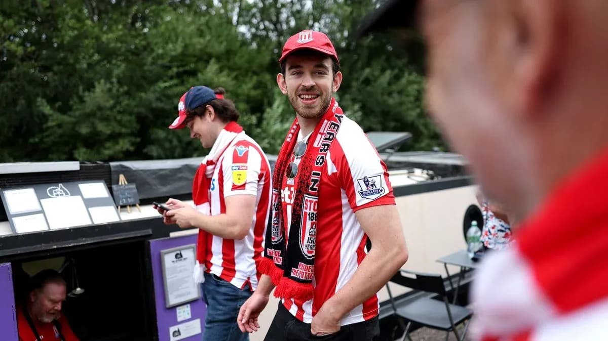 Fans wearing team jerseys and scarves at event Fans wearing team jerseys and scarves at event