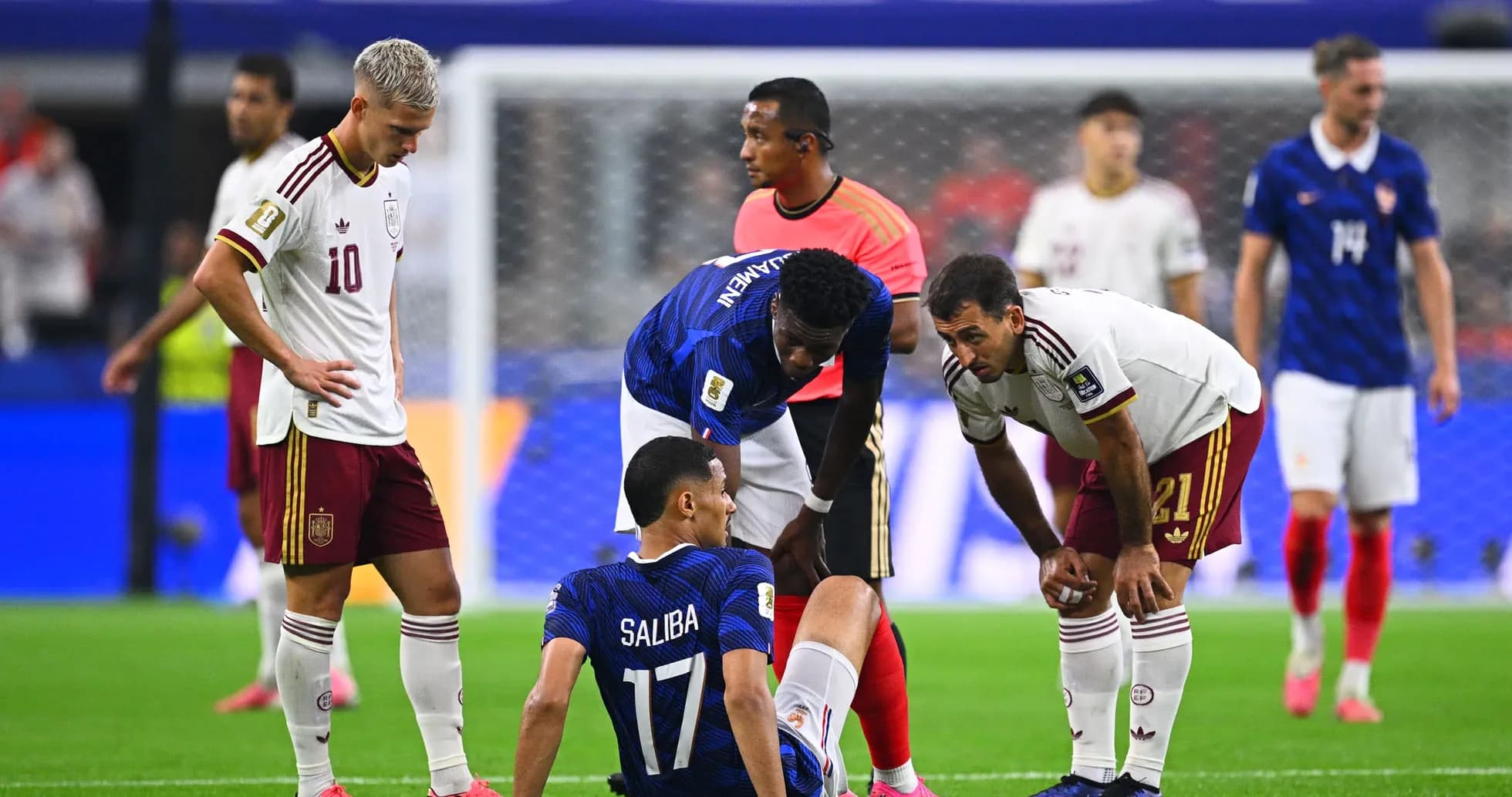 Players attending to injured teammate on field Players attending to injured teammate on field