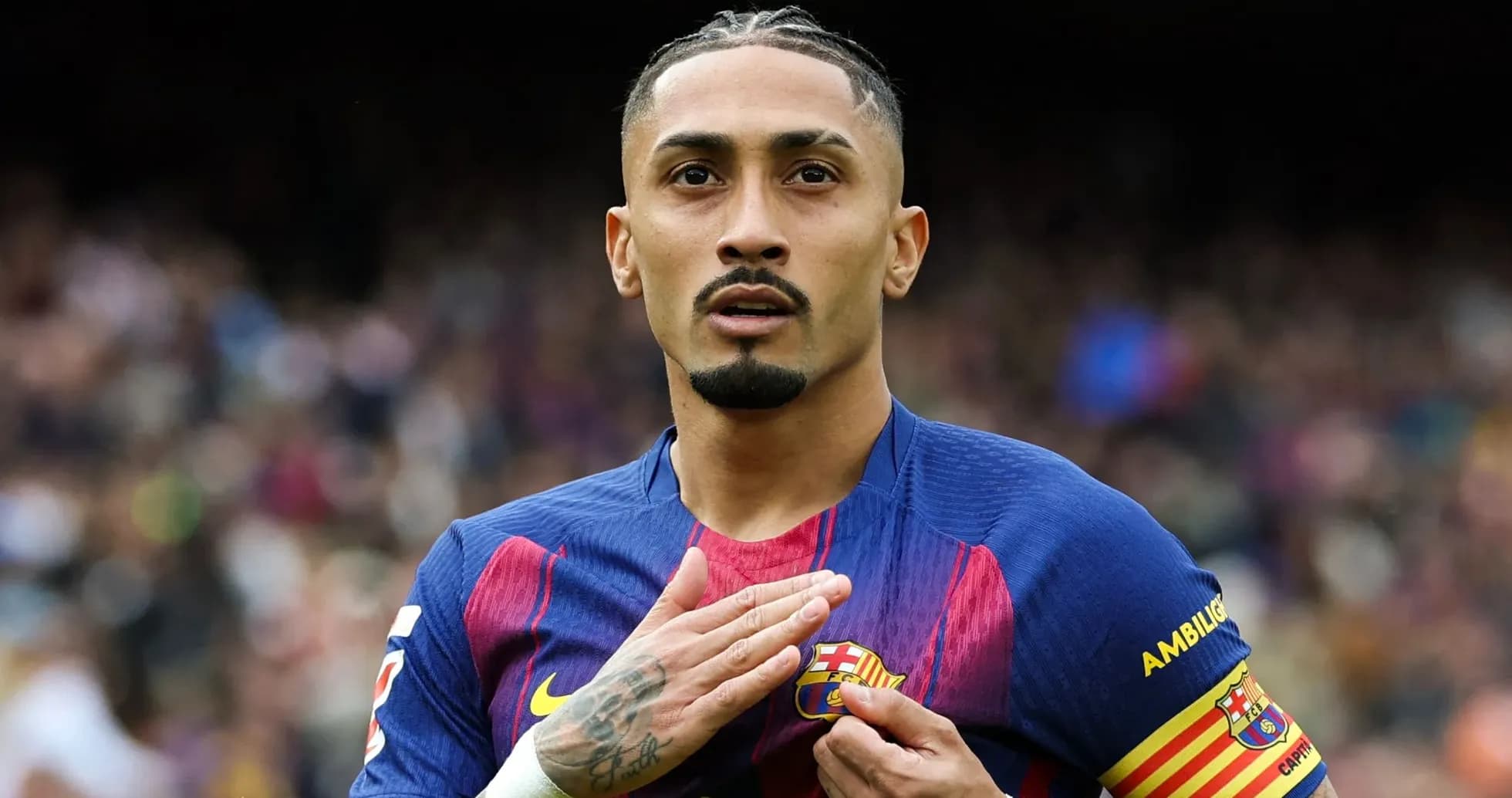 Player gesturing towards FC Barcelona crest on jersey Player gesturing towards FC Barcelona crest on jersey