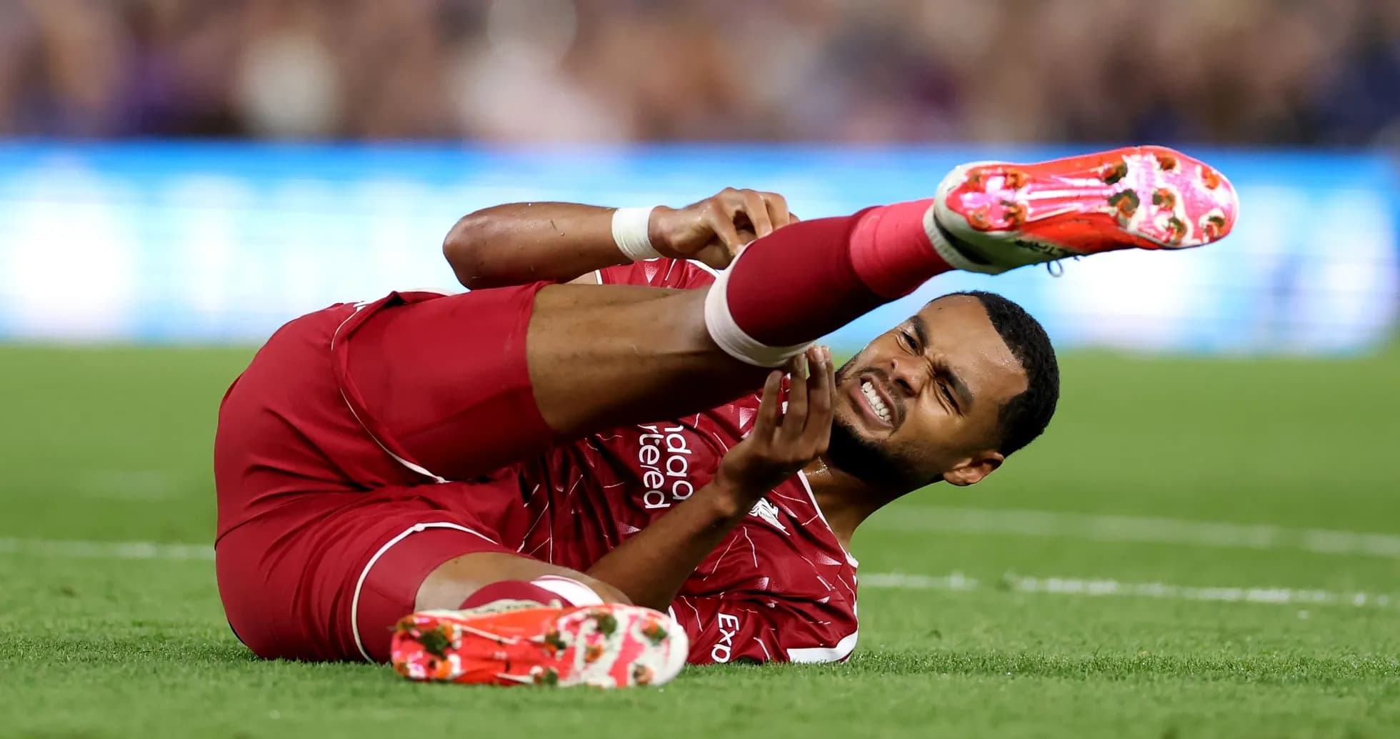 Player lying on the ground with injured leg Player lying on the ground with injured leg