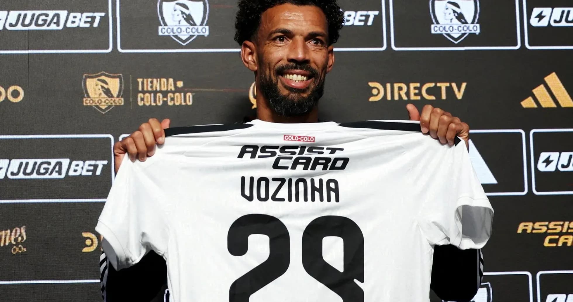 Player holding Colo-Colo jersey at presentation event Player holding Colo-Colo jersey at presentation event