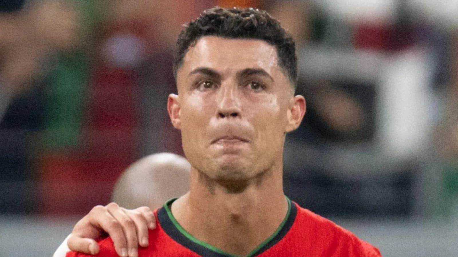 Football player wearing Portugal jersey during match Football player wearing Portugal jersey during match
