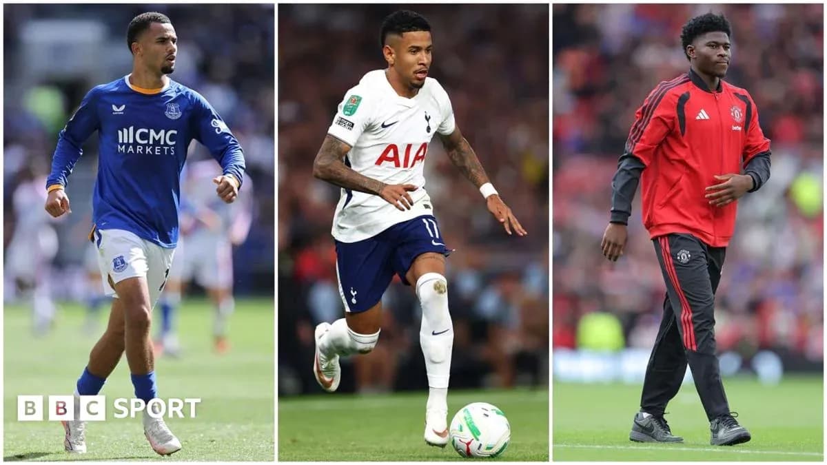Three football players in team kits on pitch Three football players in team kits on pitch