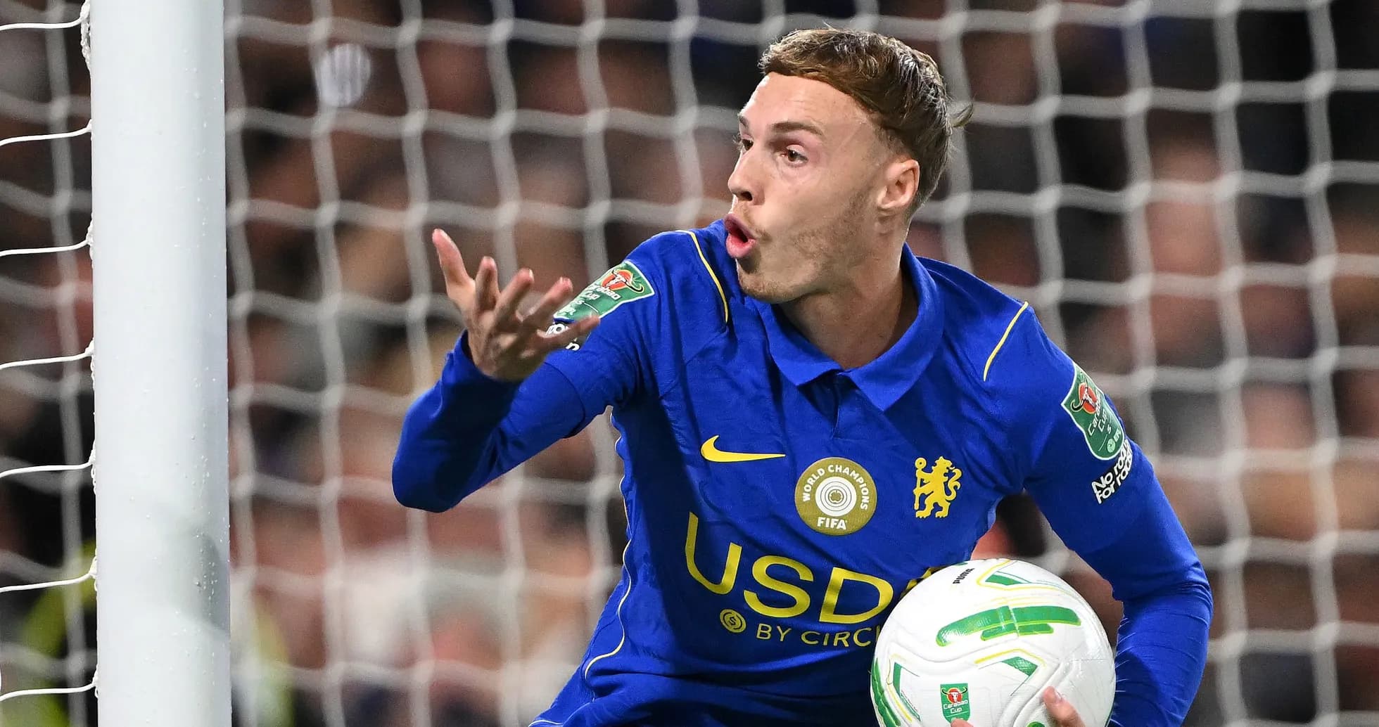 Goalkeeper in blue jersey gesturing with ball Goalkeeper in blue jersey gesturing with ball