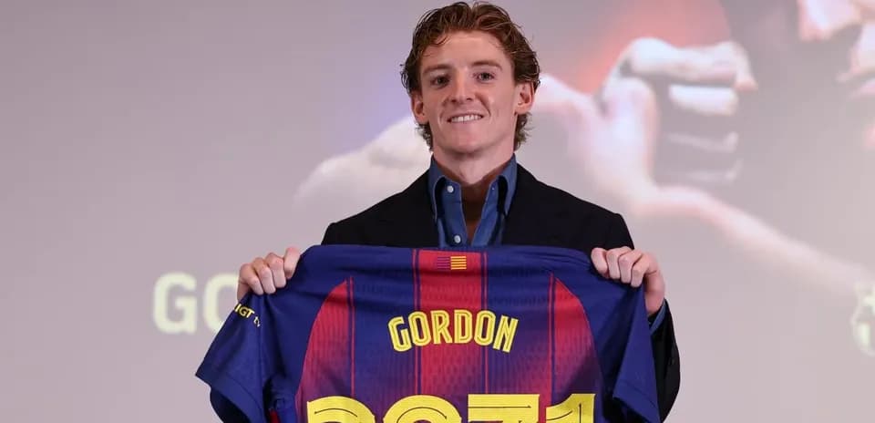 Player holding Barcelona jersey at press conference Player holding Barcelona jersey at press conference