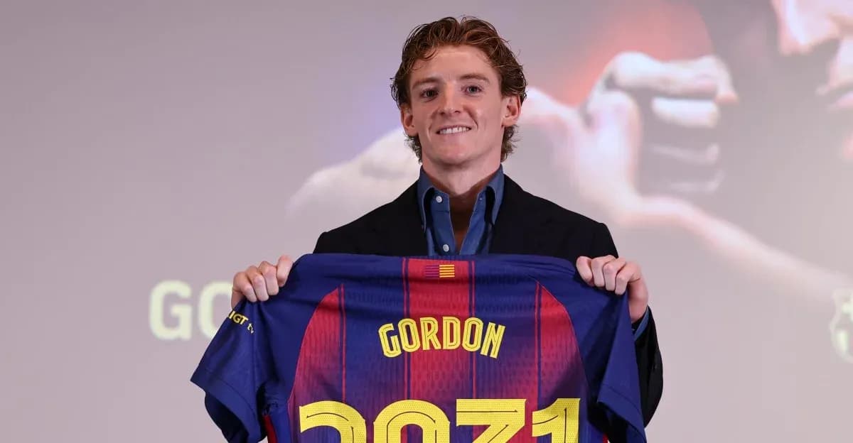 Player holding Barcelona jersey at press conference Player holding Barcelona jersey at press conference
