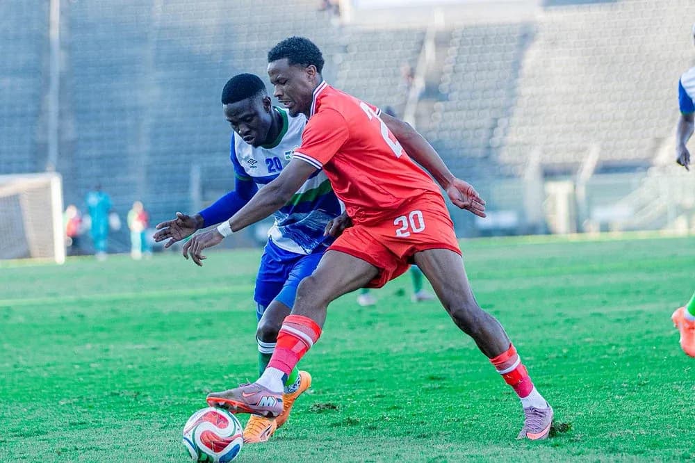 Two players competing for the ball on the field Two players competing for the ball on the field