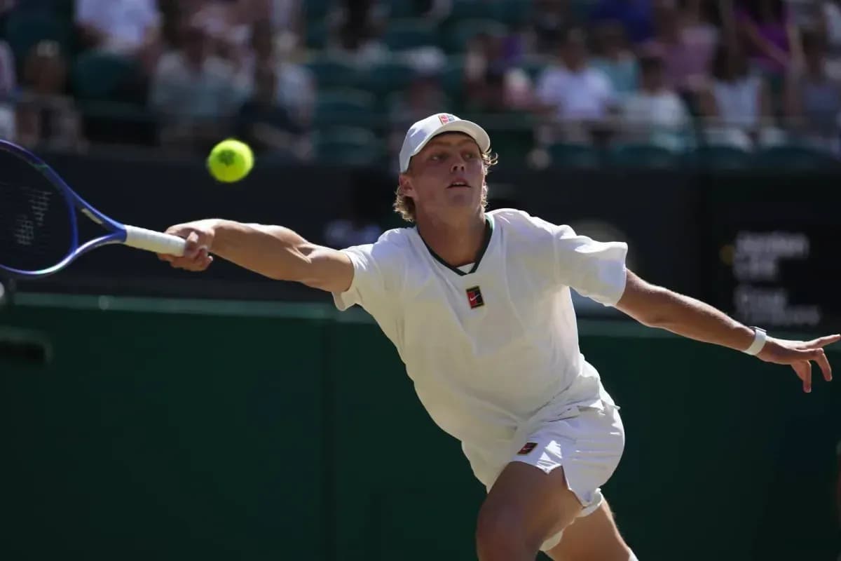 Player reaching for a tennis ball during match Player reaching for a tennis ball during match
