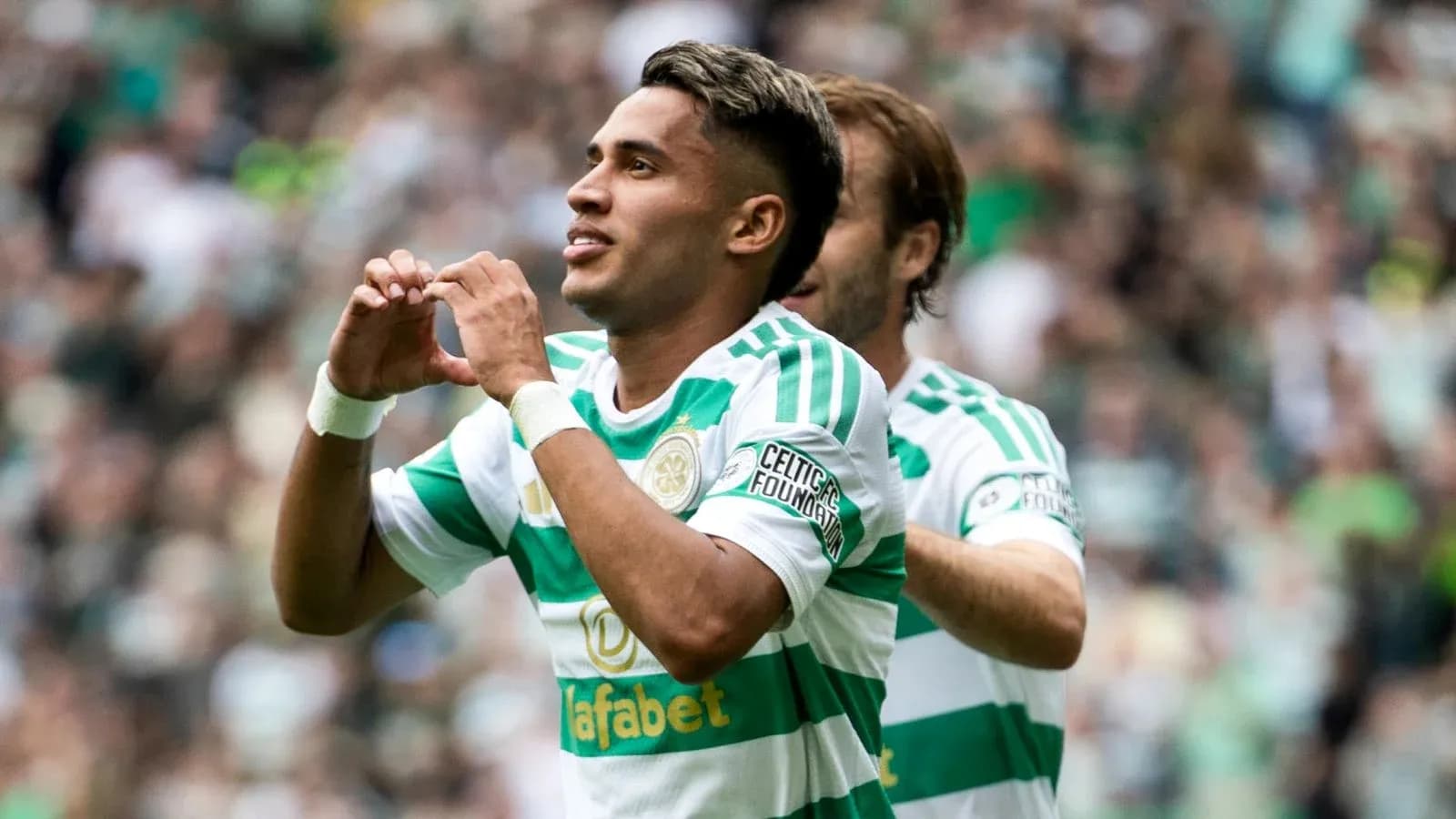 Player celebrating a goal with heart gesture Player celebrating a goal with heart gesture