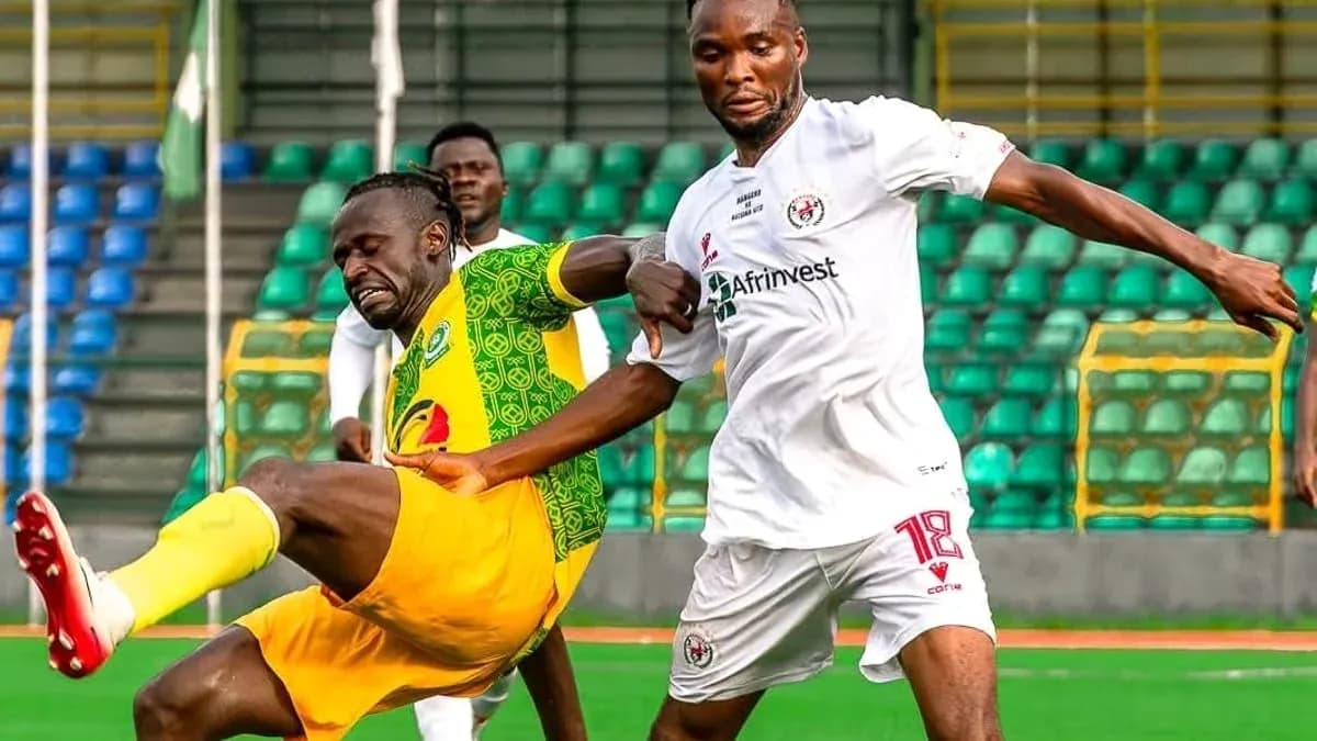 Katsina United player challenged by Rivers United opponent Katsina United player challenged by Rivers United opponent