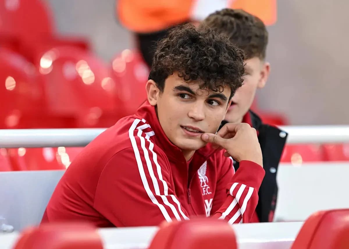 Player in Liverpool FC tracksuit on bench Player in Liverpool FC tracksuit on bench