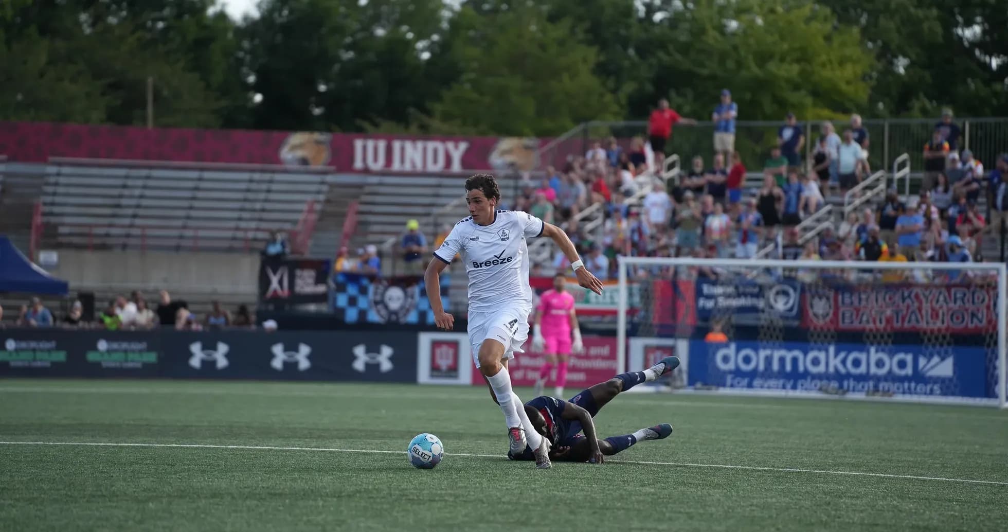 Player evading tackle during Rhode Island match Player evading tackle during Rhode Island match