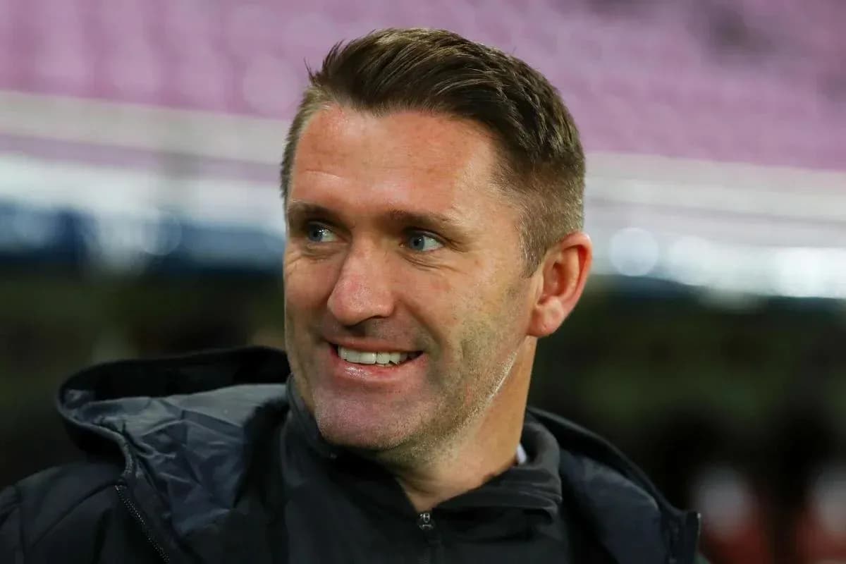 Coach smiling on the sidelines before a match Coach smiling on the sidelines before a match
