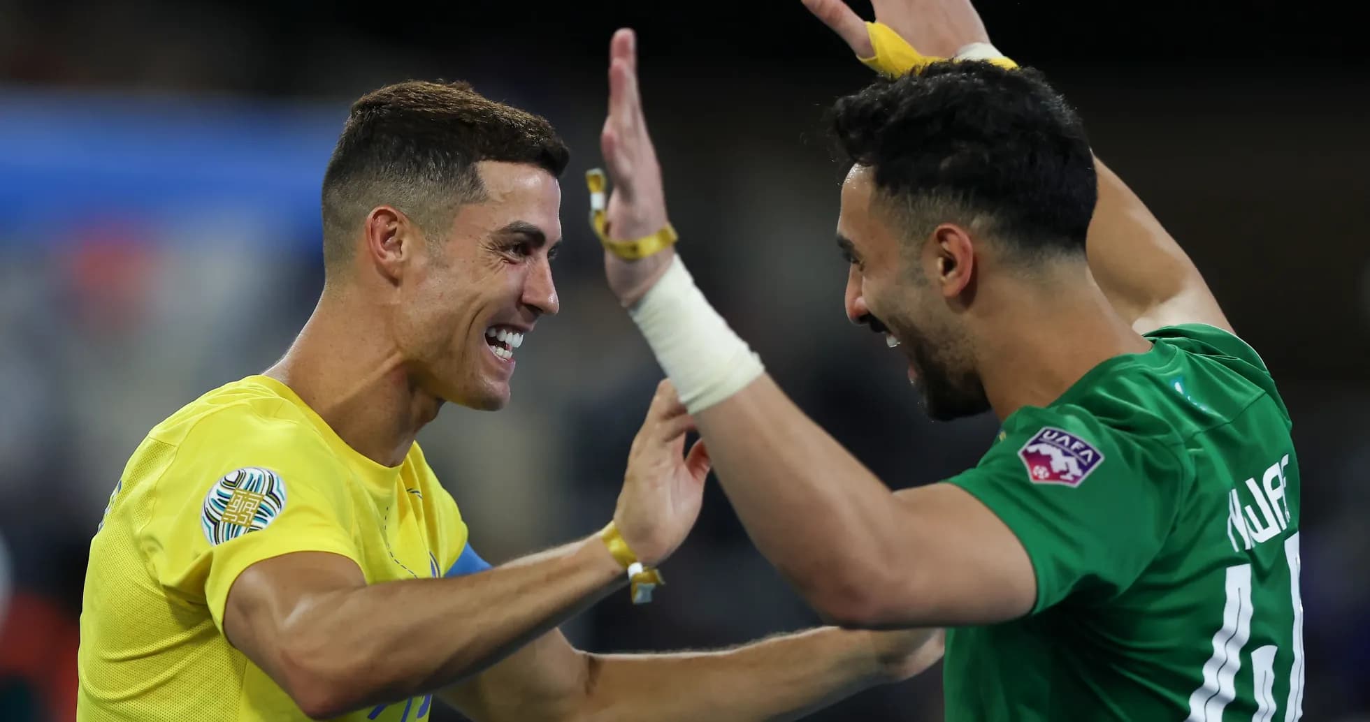 Two players celebrating a victory on the field Two players celebrating a victory on the field