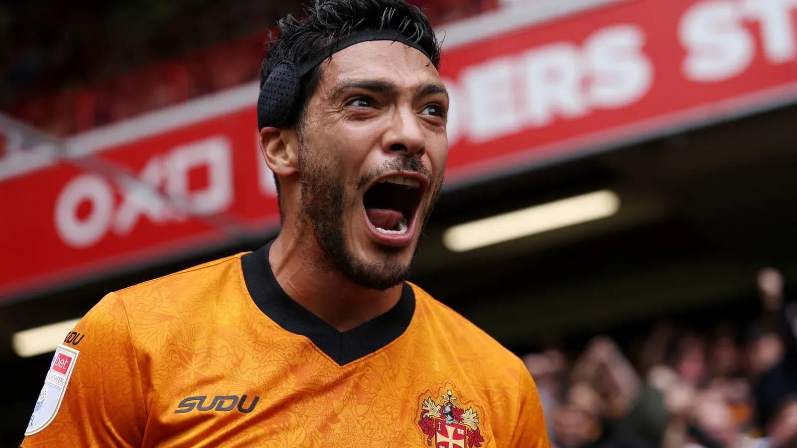 Player celebrating passionately in team jersey Player celebrating passionately in team jersey