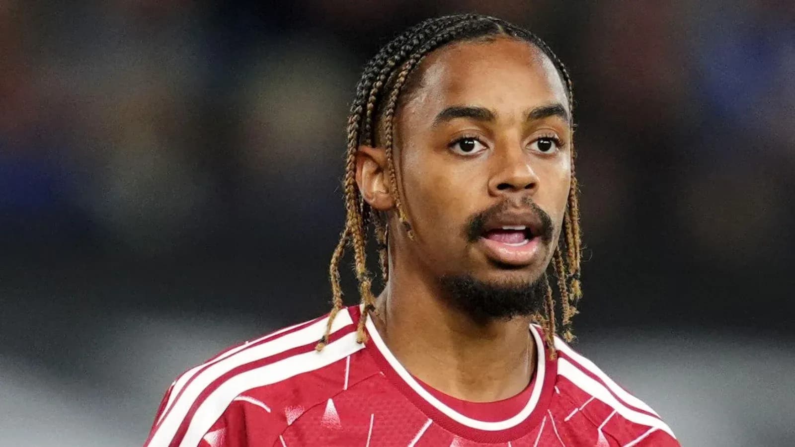 Football player in red jersey during match Football player in red jersey during match