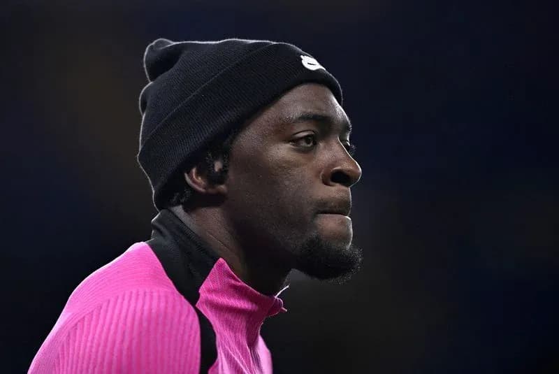Player in pink training gear wearing a black beanie Player in pink training gear wearing a black beanie