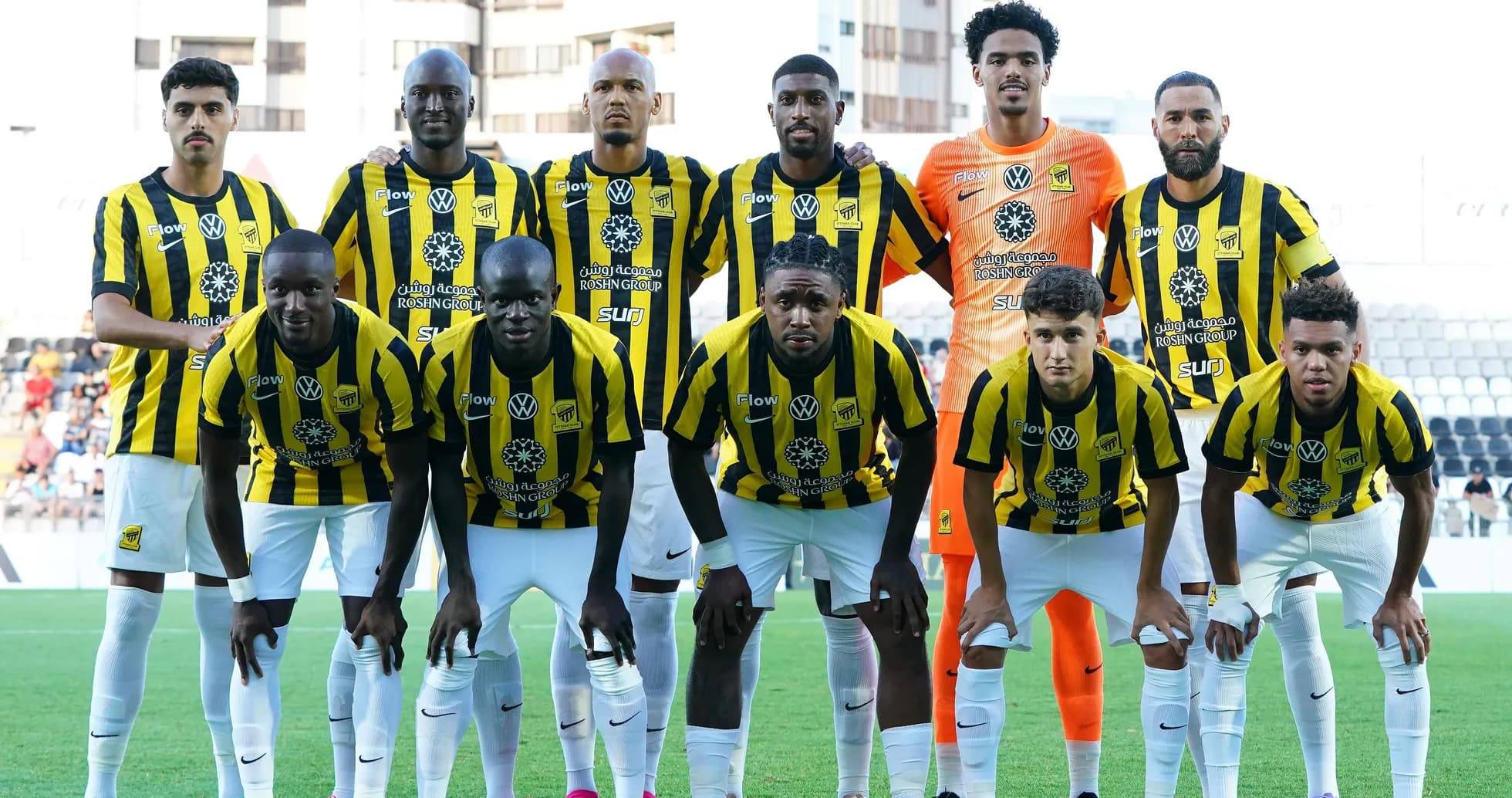 Football team posing for group photo in yellow jerseys Football team posing for group photo in yellow jerseys