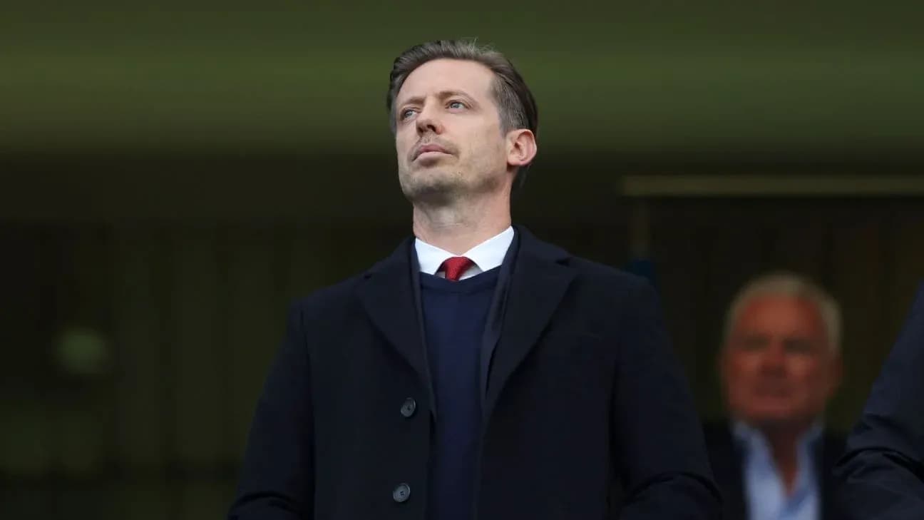 Man in formal attire observing from the stands Man in formal attire observing from the stands