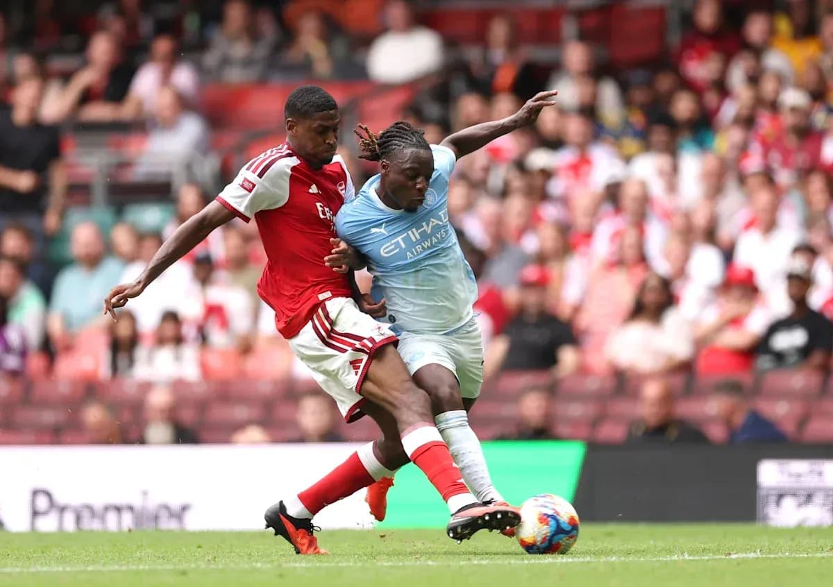 Two players contesting the ball during a match Two players contesting the ball during a match