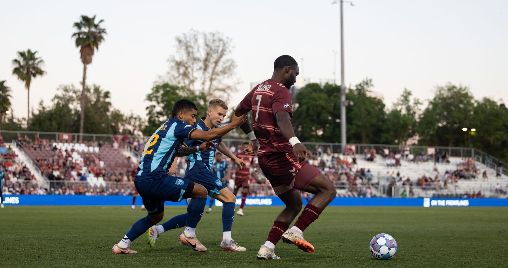 Sacramento Republic player dribbling past Monterey Bay defenders Sacramento Republic player dribbling past Monterey Bay defenders
