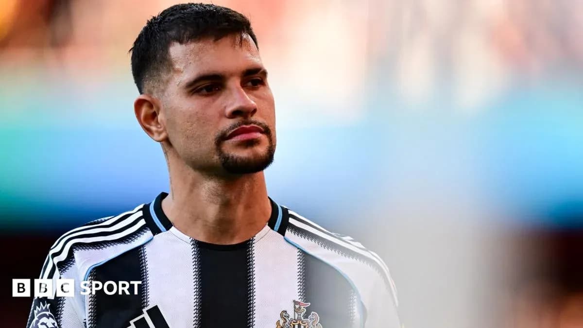 Player in Newcastle United jersey on the field Player in Newcastle United jersey on the field
