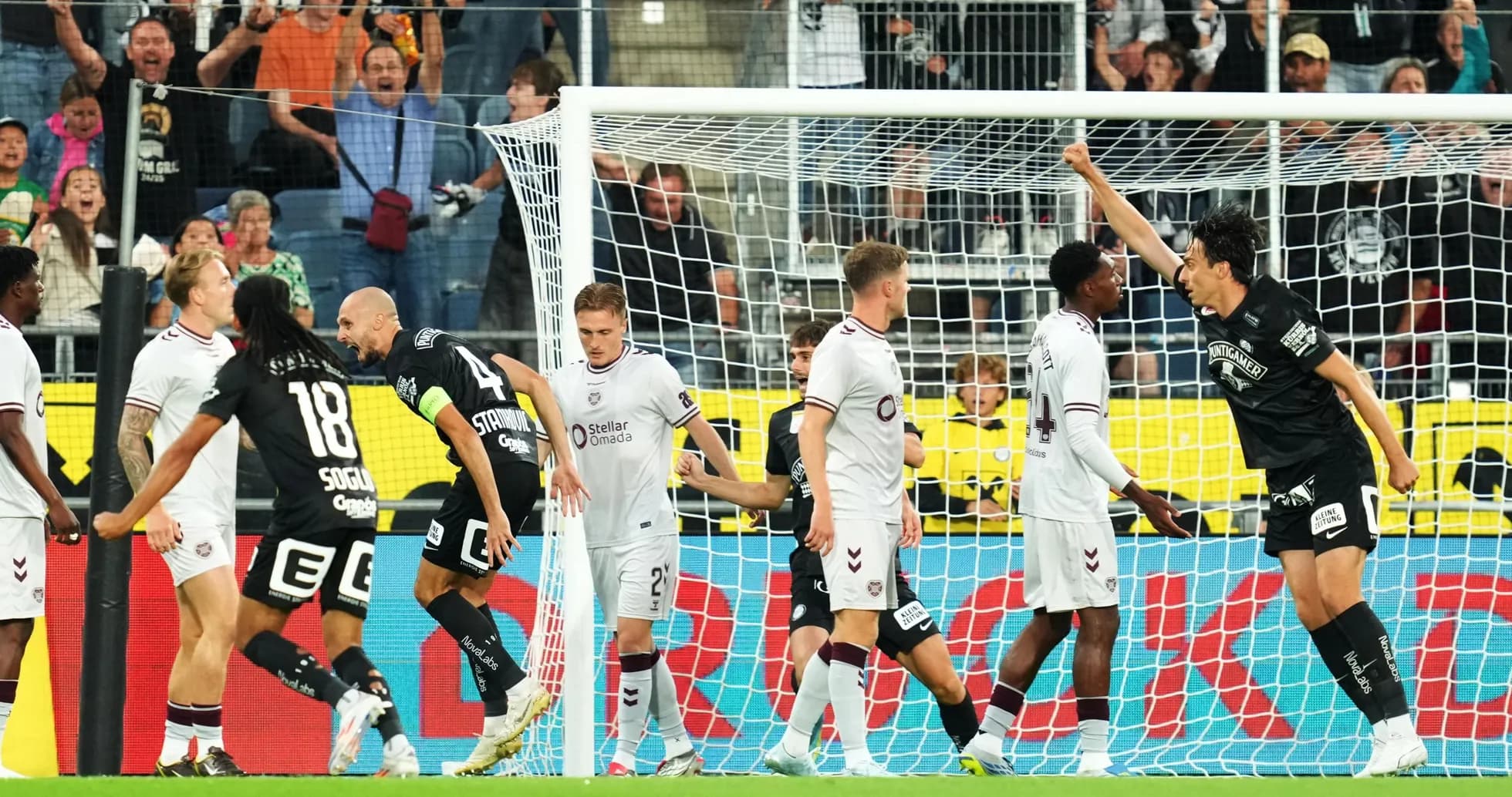 Players celebrating a goal during UEFA match Players celebrating a goal during UEFA match